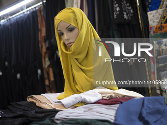 A mannequin is being covered with a mandatory headscarf during the Hijab and Chastity fair at the Imam Khomeini Grand Mosque in downtown Teh...