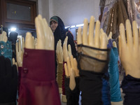 A veiled Iranian woman is looking at mannequins with hand covers while visiting the Hijab and Chastity fair at the Imam Khomeini Grand Mosqu...