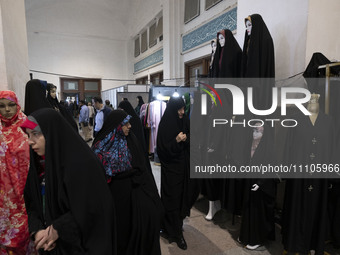 Veiled Iranian women are looking at mannequins covered with black chadors during the Hijab and Chastity fair at the Imam Khomeini Grand Mosq...