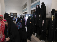 Veiled Iranian women are looking at mannequins covered with black chadors during the Hijab and Chastity fair at the Imam Khomeini Grand Mosq...