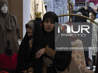 Veiled Iranian women are walking past mannequins with mandatory headscarves at the Hijab and Chastity fair in the Imam Khomeini Grand Mosque...