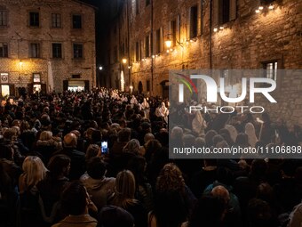 A crowd attending Dead Christ procession and people wearing white hooded costumes are seen during Good Friday procession in Gubbio, Italy, o...