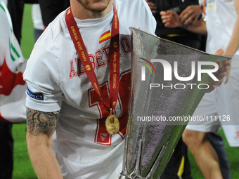 Sevilla's defender Alberto Moreno celebrate with the trophy at the end of the UEFA Europa League final football match between Sevilla FC and...