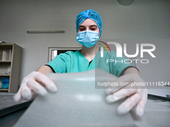 A chemist is sterilizing medicinal hydrogel dressings with UV light to speed up the healing process of burns and severe wounds in Ukrainian...