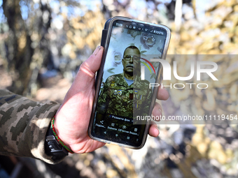 A serviceman from the 1st Tank Brigade of the Ukrainian Ground Forces is being seen on the screen of a smartphone in Ukraine, on March 31, 2...