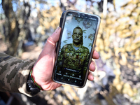 A serviceman from the 1st Tank Brigade of the Ukrainian Ground Forces is being seen on the screen of a smartphone in Ukraine, on March 31, 2...