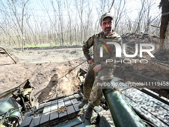 A serviceman from the 1st Tank Brigade of the Ukrainian Ground Forces is sitting on a tank gun in Ukraine, on March 31, 2024. (Photo by Ukri...