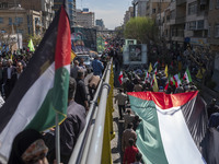 Iranian protesters are carrying a massive Palestinian flag during a rally commemorating International Quds Day, also known as Jerusalem Day,...