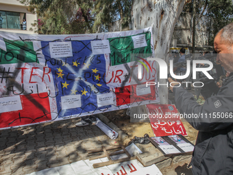 A large banner featuring the 12 gold stars of the European flag is being displayed in front of the Italian Embassy in Tunis, Tunisia, on Apr...
