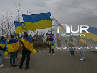 EDMONTON, CANADA - APRIL 21, 2024:
Members of the Ukrainian diaspora proudly wave national flags, hold blue and yellow balloons, and display...
