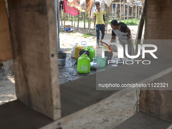 An Indian woman collect drinking water from a supply line on the World Water Day in Dimapur, India north eastern state of Nagaland on Tuesda...