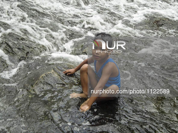 A child bathes at the decommissioned Wawa Dam in the municipality of Rodriguez, Rizal province on World Water Day, 22 March 2016. The theme...