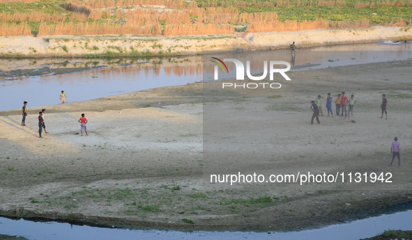 Indian youth play cricket match on the dry river bed side of Ganges River during World cup T20 , in Allahabad on March 28,2016. India has qu...