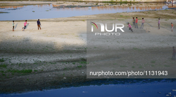 Indian youth play cricket match on the dry river bed side of Ganges River during World cup T20 , in Allahabad on March 28,2016. India has qu...