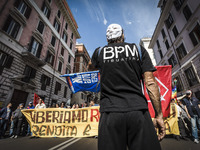 Rome, Italy – May 17, 2014: A protester with a Guy Fawkes mask take parts at a nationwide demonstration against the privatization of the com...