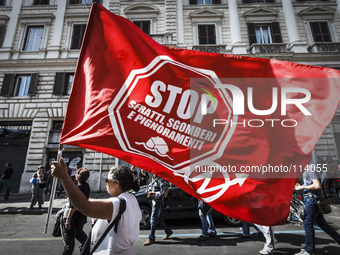 Rome, Italy – May 17, 2014: Protesters wave flags during a nationwide demonstration against the privatization of the commons and the austeri...