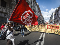 Rome, Italy – May 17, 2014: Protesters wave flags and hold banners during a nationwide demonstration against the privatization of the common...