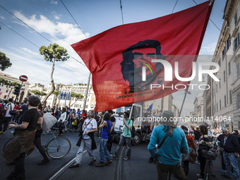 Rome, Italy – May 17, 2014: Protester waves a flag with Che Guevara face as he demonstrate during a nationwide demonstration against the pri...