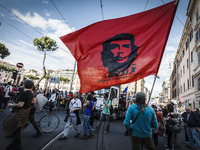 Rome, Italy – May 17, 2014: Protester waves a flag with Che Guevara face as he demonstrate during a nationwide demonstration against the pri...