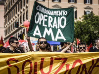 Rome, Italy – May 17, 2014: Protesters shout slogans and hold banners during a nationwide demonstration against the privatization of the com...