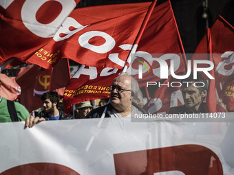 Rome, Italy – May 17, 2014: Protesters wave flags and hold banners during a nationwide demonstration against the privatization of the common...