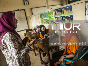 A teacher give a lesson for student in special school childern for physical disabilities in Special School PRI, Pekalongan, Central Java, In...