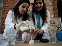 Women preparing a minor experiment. Athens Science Festival to Technopolis for a third consecutive year, with a focus on “Evolving with Scie...
