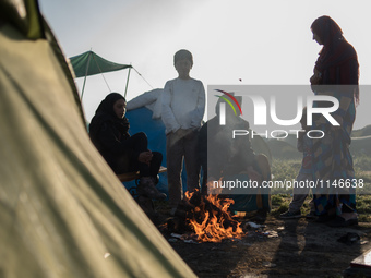 Family warming up early in the morning in Idomeni camp on April 6, 2016.. A plan to send back migrants from Greece to Turkey sparked demonst...