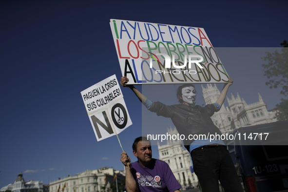 Protestors display banners during a protest against austerity, banners say 