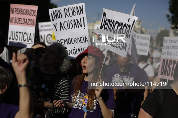 Protestors shout slogans and display reivindicative banners during a protest against austerity in Madrid, Spain , May 17th 2014. Protestors...