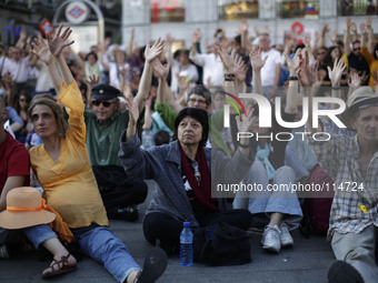 Protestors raise their hands as they attend an assembly at la puerta del sol after a protest against austerity in Madrid, Spain , May 17th 2...