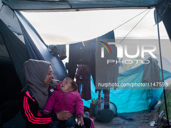 Mum and her baby waking up, in Idomeni camp on April 5, 2016. (
