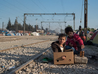 Kids playing with a box early in the morning in Idomeni camp on April 6, 2016. (