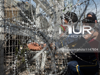 Children taking out the fences of the border in the Macedonian border on April 7, 2016 (