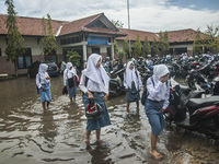 Number of student walking in flooded  high school SMKN 1, Village Kramat Sari, Pekalongan, Central Java, Indonesia, on April 11, 2016. The f...