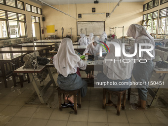 Number of student studying in flooded classroom in high school SMKN 1, Village Kramat Sari, Pekalongan, Central Java, Indonesia, on April 11...