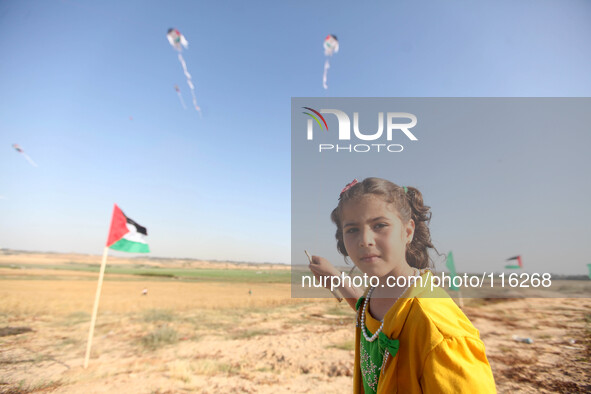 Flew kites Palestinian children, some carrying Palestinian and figures anniversary of the  their solidarity in the memory of the 66 Palestin...