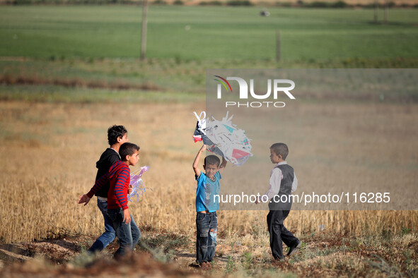 Flew kites Palestinian children, some carrying Palestinian and figures anniversary of the  their solidarity in the memory of the 66 Palestin...