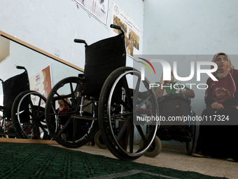 A woman sits in a wheelchair a during Disabled Palestinian volleyball of Women's a participates in Exercise a in Club Deir al-Balah in the c...