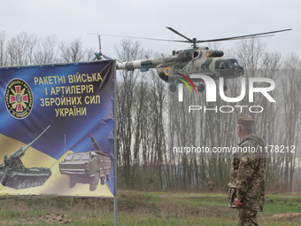 A Ukrainian military helicopter flies over the shooting range during the visit of Ukrainian President Petro Poroshenko (not pictured), at th...