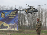 A Ukrainian military helicopter flies over the shooting range during the visit of Ukrainian President Petro Poroshenko (not pictured), at th...