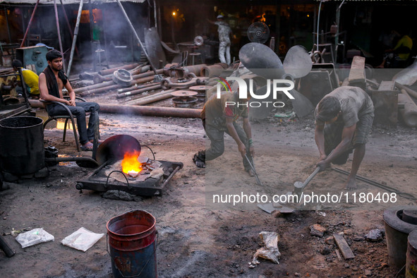 Worker is breaking metal into small peices to put into the furnace. Ship building industry in Bangladesh spreading rapidly where workers fro...