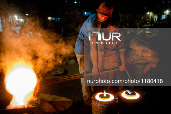 Pouring melted brass into the most to make propeller, in Dhaka, Bangladesh, on April 28, 2016. Ship building industry in Bangladesh spreadin...