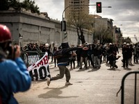 Chilean students clash against riot police during a demonstrantion near the Congress headquaters where Chilean President Michelle Bachelet d...
