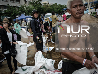 Anti government protesters continue to build sand bag barricades in the centre of Bangkok to protect from suspected attacks after the milita...