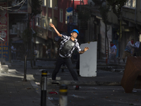 Protesters took to the streets in the Alevi enclave of Okmeydani in Istanbul on May 22, 2014 in reaction to the killing of Ugur Kurt. Kurt w...