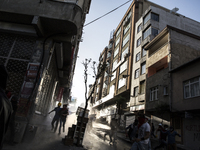 Protesters run from water cannons and tear gas in the Alevi enclave of Okmeydani in Istanbul on May 22, 2014 in reaction to the killing of U...