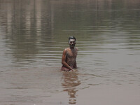 A pakistani man bathing in ravi river for cool themselves due to hot weather in Lahore, Pakistan, on May 06, 2016. (