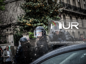A police point of flashball LBD to the protesters and photographers during a protest after the French government made use of the constitutio...