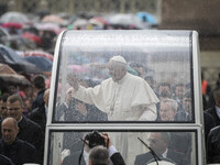 Pope Francis rides on the Popemobile through the crowd of the faithful as he arrives to celebrate an extraordinary Jubilee Audience as part...